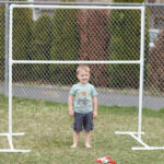 Materials needed to build a photo backdrop stand, including PVC pipes, connectors, end caps, saw, measuring tape, and clamps