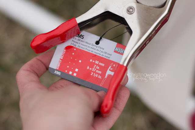 Heavy-duty clamps securing a fabric backdrop to the DIY photo backdrop stand