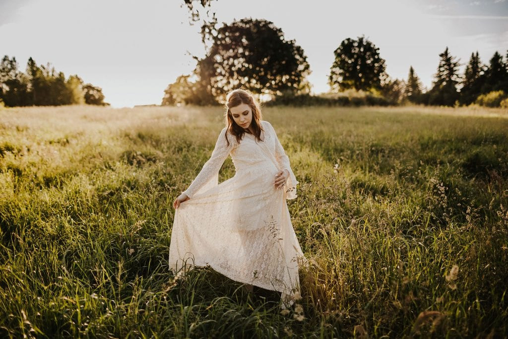 maternity photography in lace dress, showcasing a delicate lace fabric that enhances the subject's elegance. The light and airy setting complements the dress, creating a romantic and ethereal maternity portrait.