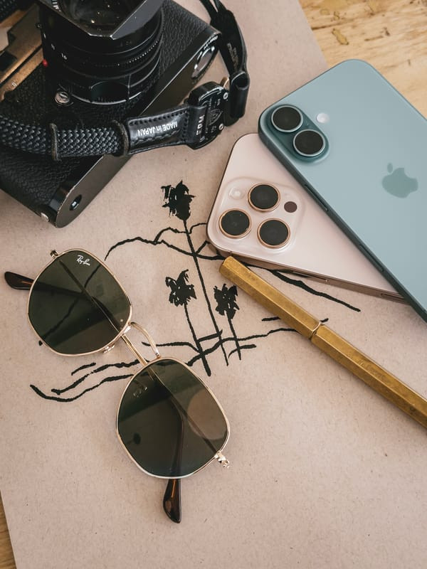 iPhone 16 in teal, showing vibrant color and stacked sensor array, capturing the unique colored glass process.
