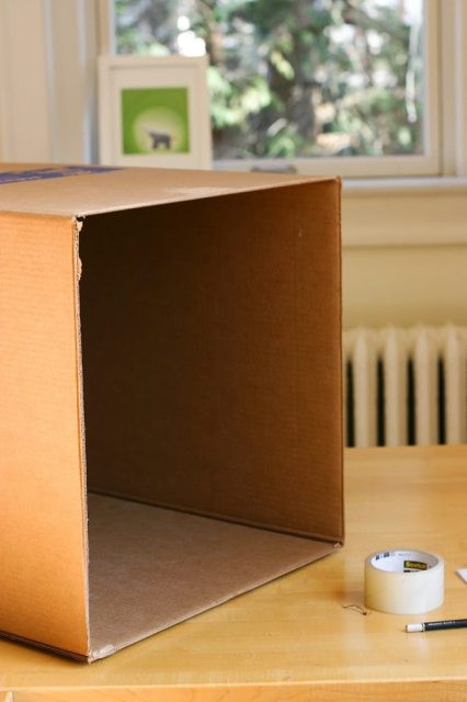 Cardboard box with cut openings for lightbox creation, ensuring neat edges and structural integrity