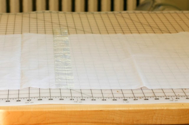 Tissue paper being attached to a lightbox frame to diffuse light effectively, enhancing illumination for photography