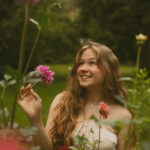 girl smiling amongst flowers