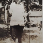 Women in 1920s attire pose with fishing catch, embodying the era's leisure activities