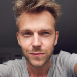 Man looking confidently into the camera in a Tinder profile