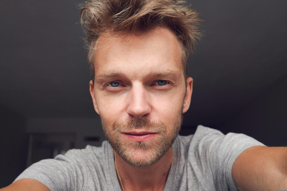 Man looking confidently into the camera in a Tinder profile