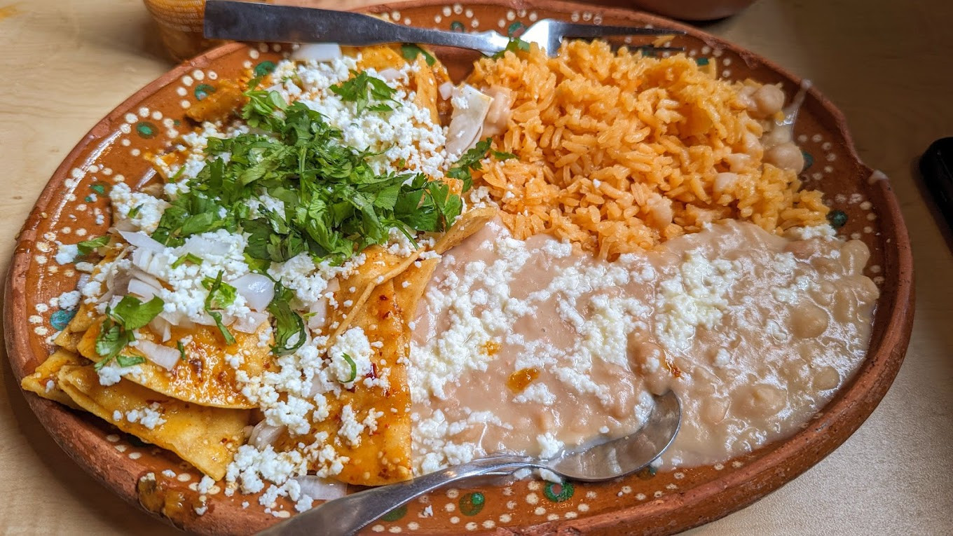 chilaquiles rojos, with beans, cheese, and rice.
