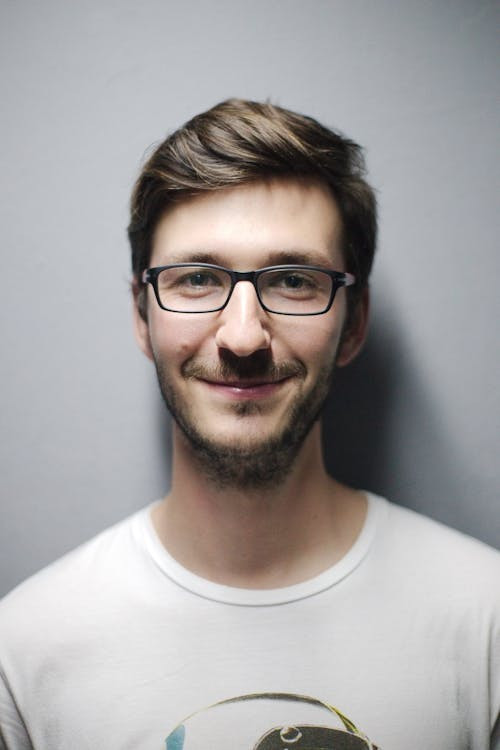 Close-up portrait of a man smiling, resized to 600x600 pixels, optimal lighting, high resolution, dfphoto.net
