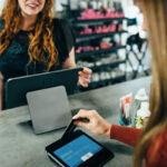 Woman using Adobe Lightroom on a laptop to edit photos for Instagram