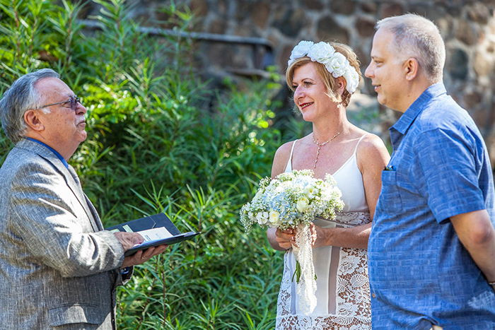A wedding portrait of a couple being married outdoors