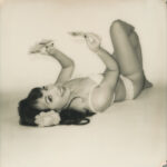 Ramona Romance on Polaroid Originals black and white 600 film, model striking a pose with moody lighting