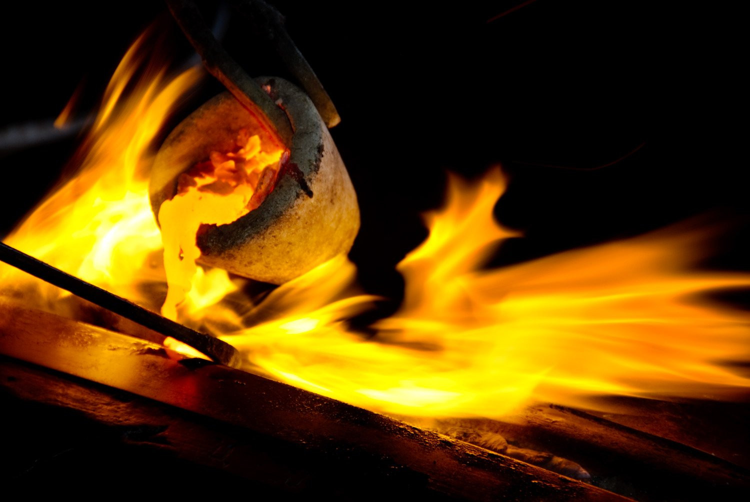 Portfolio of KevinLJ Bronze Crucible captures small crucible pouring molten bronze at a foundry.