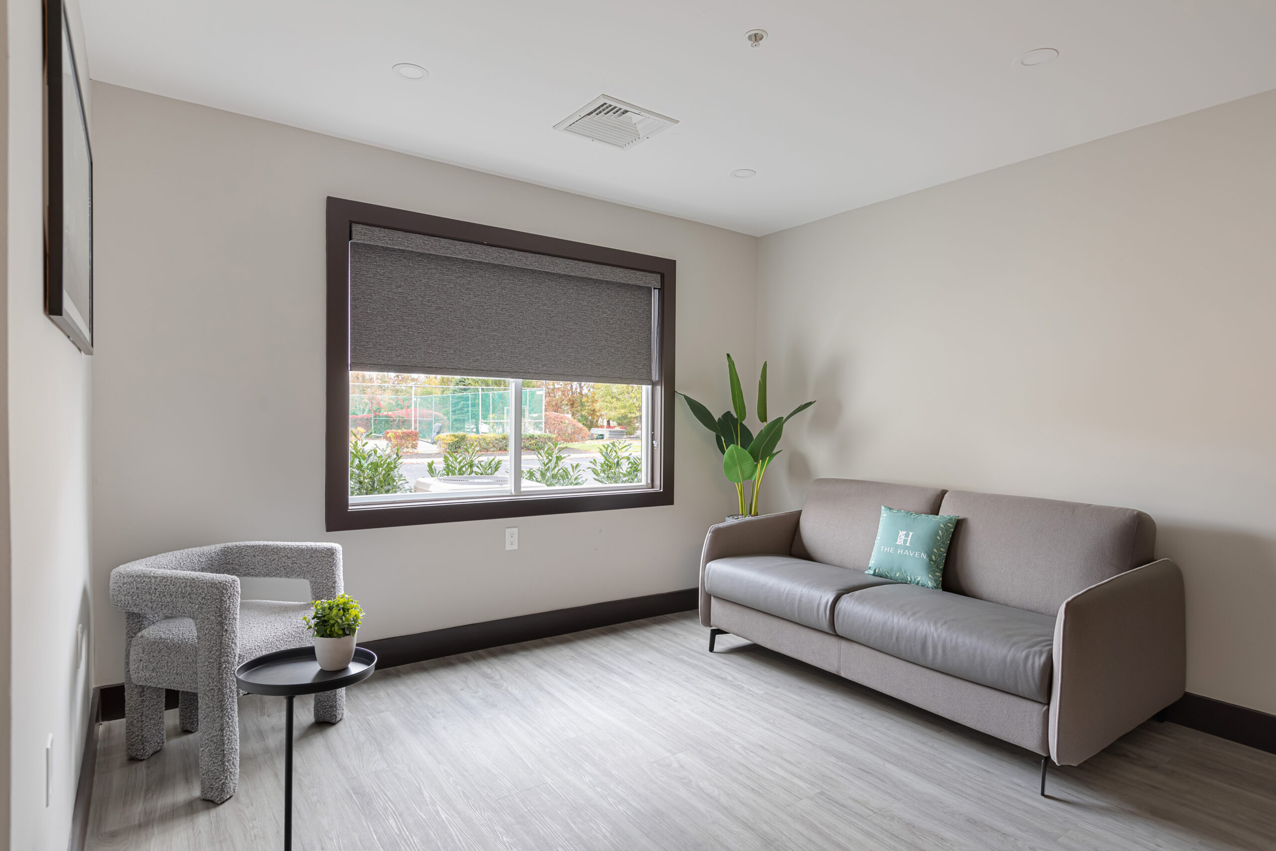 A couple enjoying a cozy sitting area inside The Haven at Westwood, complete with comfortable furniture and warm lighting