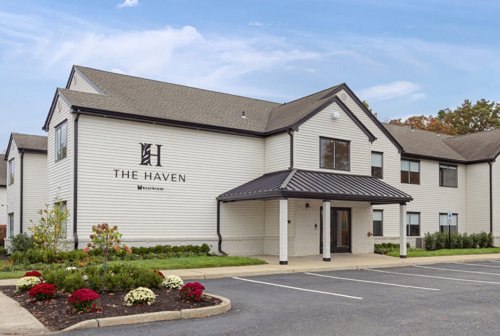Exterior view of The Haven at Westwood featuring well-maintained landscaping and ample parking, showcasing the hotel's welcoming ambiance