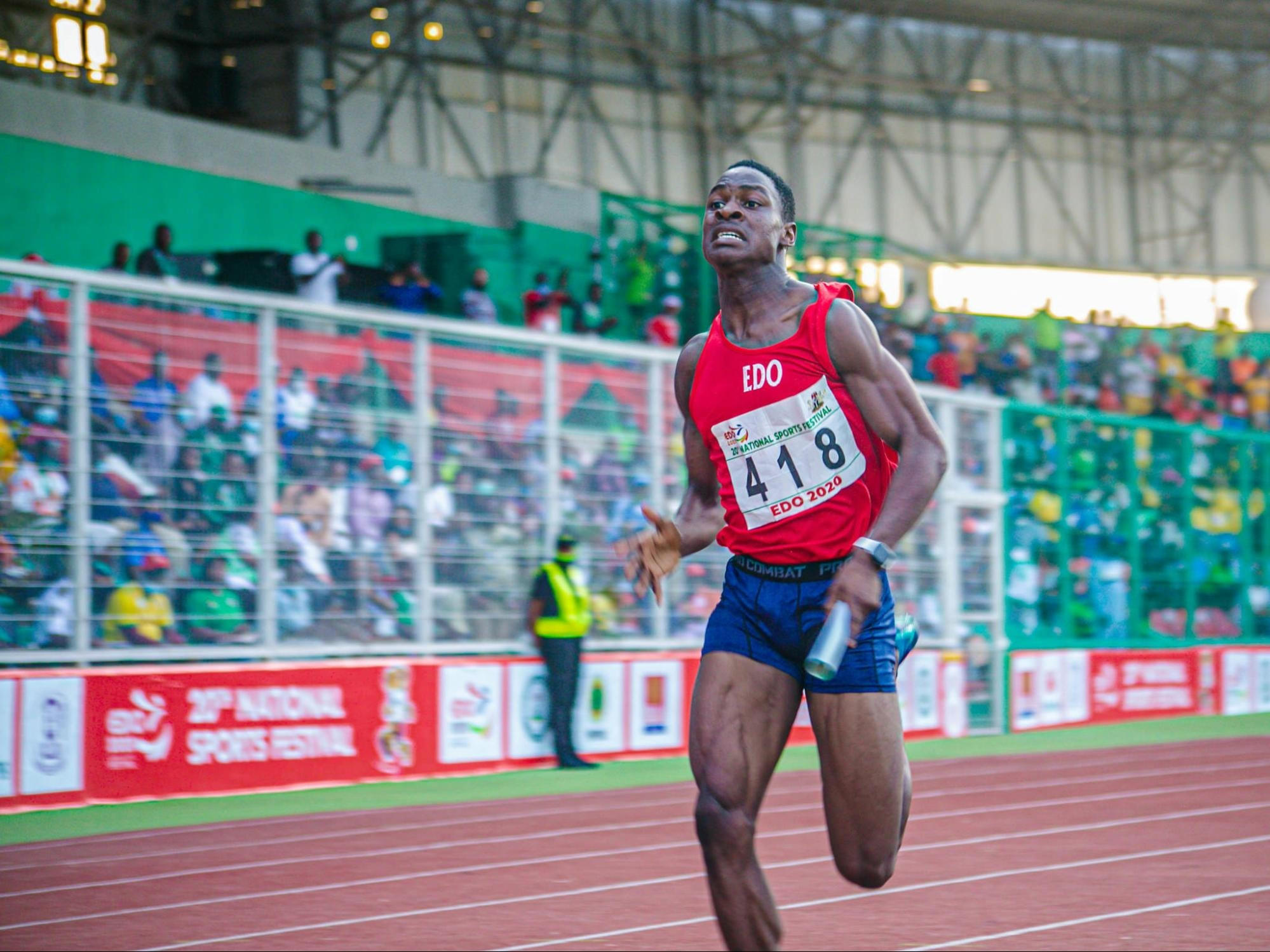 Male track athlete mid-sprint, showcasing speed and athletic form.