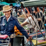 Samlor rider in Chiang Mai, Thailand, captured with a Nikon D800 and a 50mm lens, showcasing an engaging composition