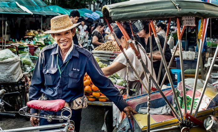 Samlor rider in Chiang Mai, Thailand, captured with a Nikon D800 and a 50mm lens, showcasing an engaging composition