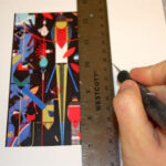 Trimming an image out of paper using a ruler and craft knife