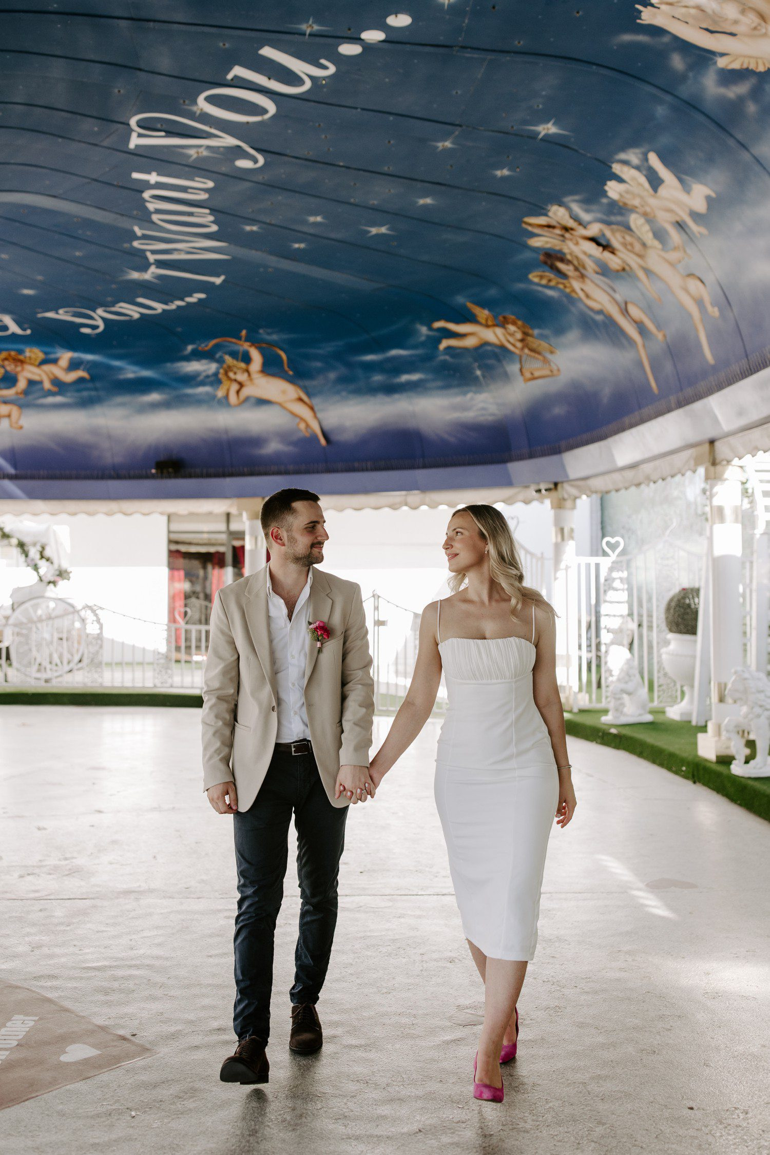 Couple walking in the Tunnel of Love at A Little White Chapel Las Vegas, capturing the playful and romantic atmosphere
