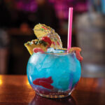 Why Kiki's vibrant atmosphere captured in a photograph, showcasing the bar's unique decor and lively patrons