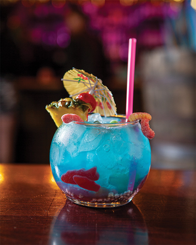 Why Kiki's vibrant atmosphere captured in a photograph, showcasing the bar's unique decor and lively patrons